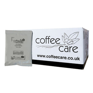 White box of Coffee Care Colombia Huila Fusion filter coffee. 1 grey recyclable packet of coffee then up against the box