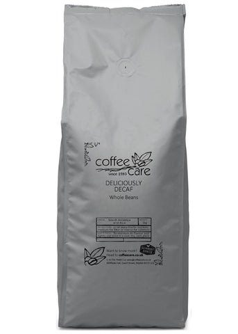 one kilo grey recyclable packet of Coffee Care's Deliciously Decaf Beans. Decaffeinated South America and Asia Beans