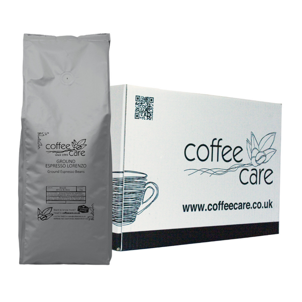 one white Coffee Care box with a grey recyclable kilo packet of Coffee Care's Espresso Lorenzo Ground Espresso Beans lent up next to it. Coffee from Brazil, Africa and Asia pre ground for espresso.