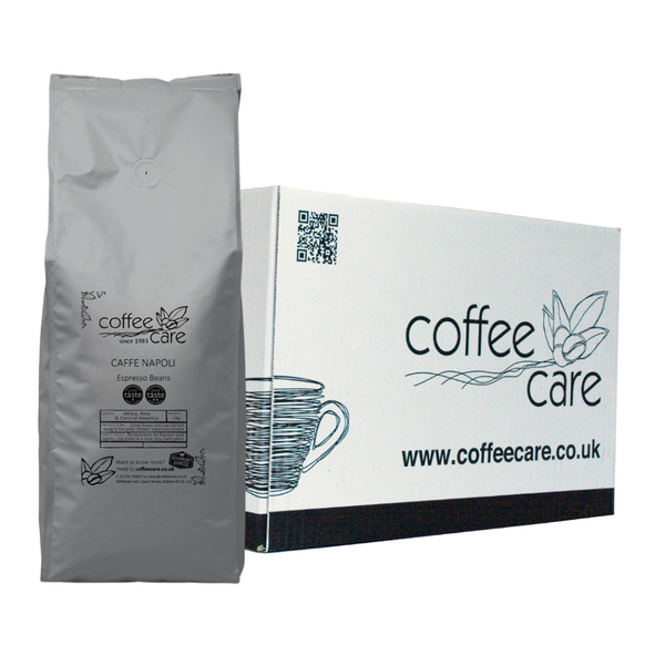 one white Coffee Care box with a grey recyclable kilo packet of Coffee Care's Caffe Napoli Espresso Beans lent up next to it. Great Taste Winner 2018 and 2022