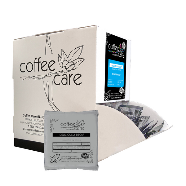 Coffee Care dispenser box of 100 grey recyclable packets of 15g Deliciously Decaf cafetiere coffee. A white dispenser box with 1 cafetiere sachet lent up next to it.