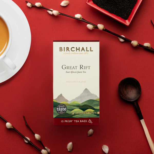 birds Birchall Great Rift box of 15 prism tea bags. Deep red background with brewed tea, spoon, twigs 