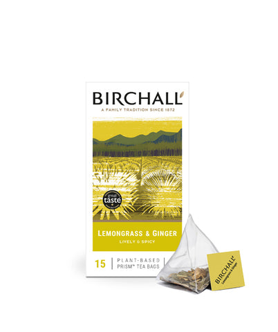 Front view of cardboard box of 15 Birchall Lemongrass & Ginger prism tea bags. Yellow hill graphics with yellow band, lively & spicy, natural infusion. Caffeine free. with one prism teabag on display next to box