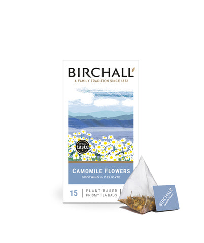 Front view of cardboard box of 15 Birchall Camomile prism tea bags. Blue hill graphics, soothing & delicate, natural infusions, caffeine free, great taste winner 2014. with 1 prism teabag next to box