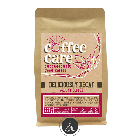 A 227g kraft packet of Coffee Care’s Deliciously Decaf ground coffee. Pink label ground for filter & cafetiere. Freshly ground Asia & South America Coffee.